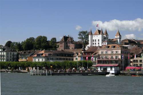 Shoreline Buildings with castle in Nyon, Switzerland free photo