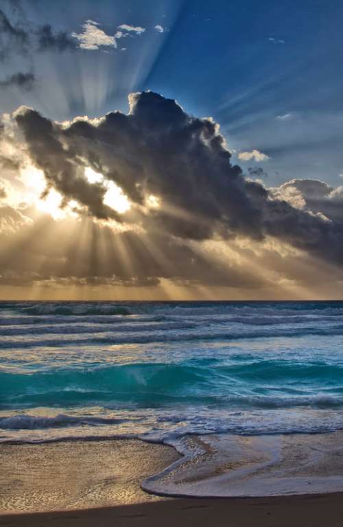 Sun Behind the clouds over the Sea in Cancun, Mexico free photo