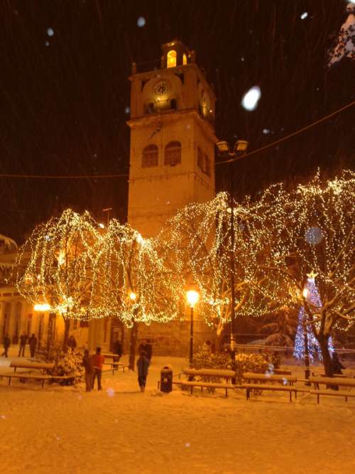 The clock tower during Christmas with Lights in Kozani, Greece free photo