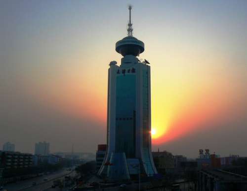 Tower in front of the setting sun in Tianjin, China free photo