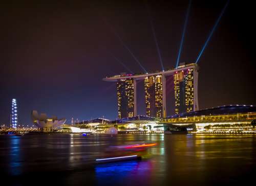Triple towers and lights in cityscape of Singapore free photo