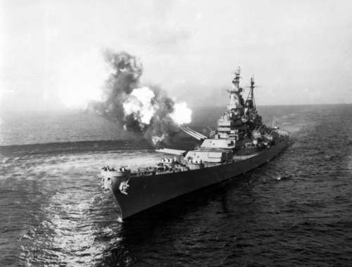 USS Missouri fires a salvo from its 16-inch guns at shore targets during Korean War free photo