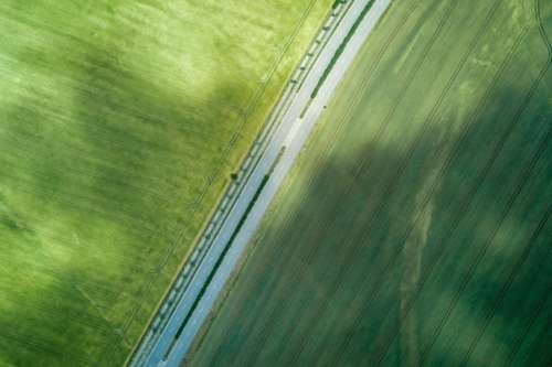 Aerial view of a road in the middle of a field