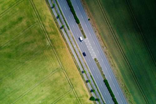 Aerial view on highway by the field at summer