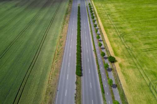 Aerial view on highway by the field at summer
