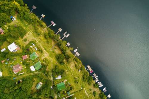 Amazing aerial view. Houses in the woods near the river at summer