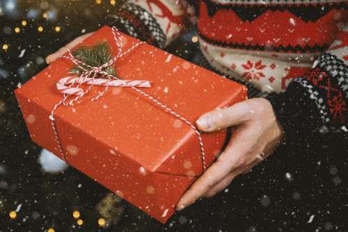 Man’s hands hold christmas gift box. Merry Christmas