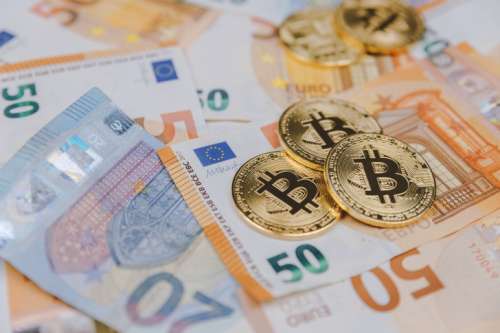 Bitcoins and euros, money and currency exchange rate concept