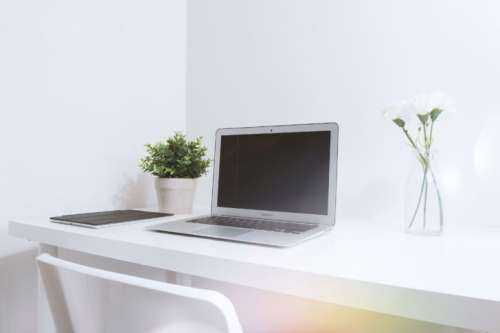 Modern white office interior with laptop