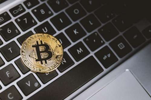 One golden bitcoin on keyboard