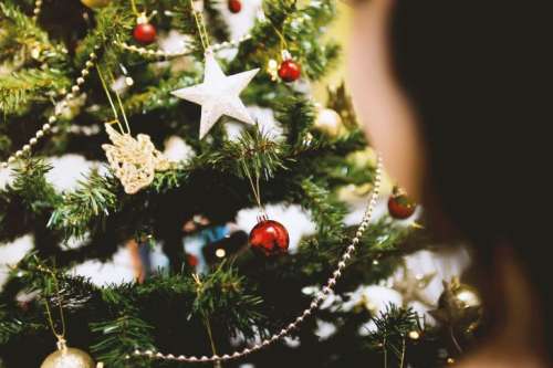Young girl by the Christmas tree