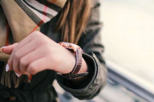Young woman on the street and detail of fashion watches