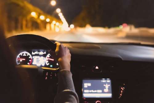 Young woman driving a car at night