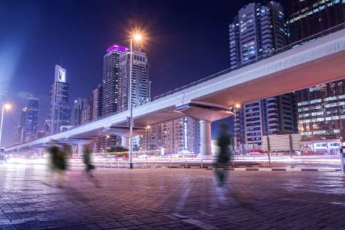 Amazing night atmosphere in Dubai. People on the street in motion