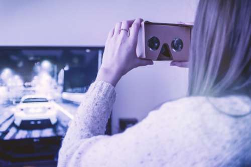 Girl uses cardboard for virtual reality at home