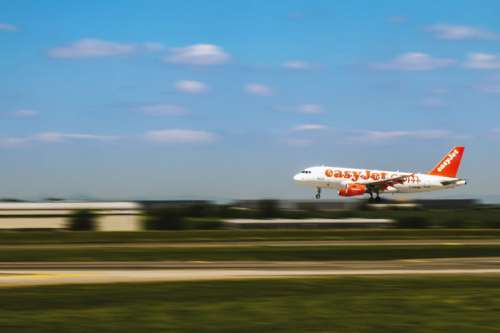 Airplane is landing at the airport in motion