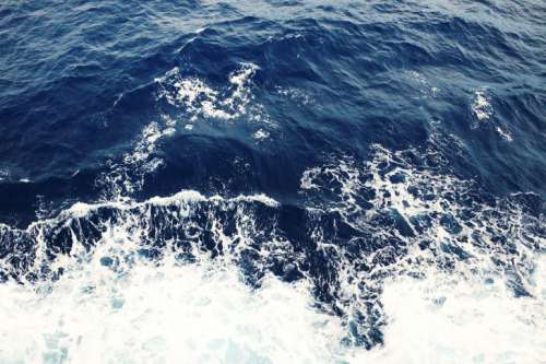 Waves from a boat in the middle of the ocean