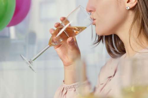 Girl drinking a glass of champagne