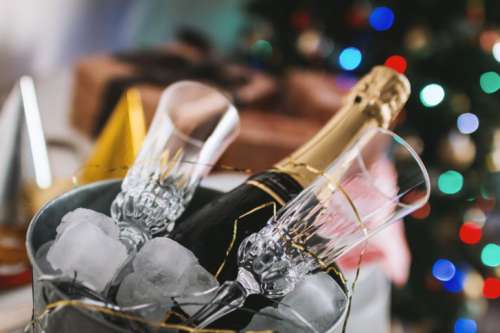 Party! Glasses and bottle of Champagne in an ice container. Happy New Year concept.