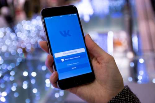 Display with login to the social network Vkontakte on modern smartphone in hands