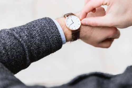 Man with clock checks the time