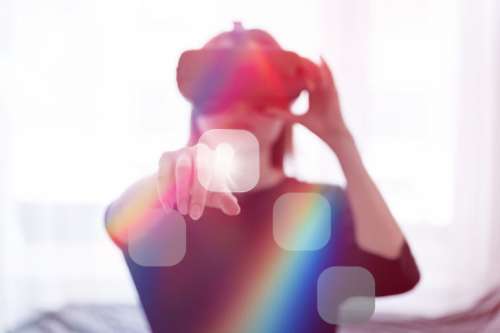 Woman wearing virtual reality goggles in her modern studio