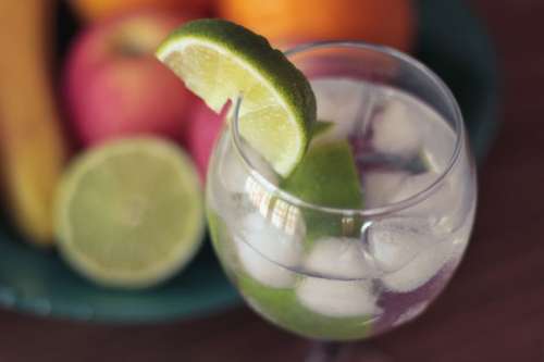Detail of drink with lime and other fruit
