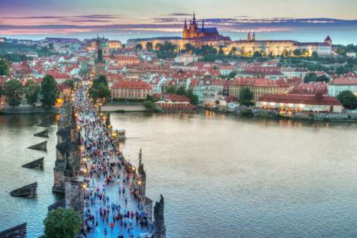 Evening in the historic center of Prague and view on the Charles Bridge