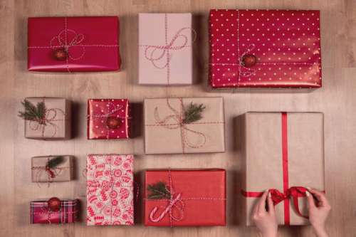 Collection of Christmas presents arranged on a wooden background