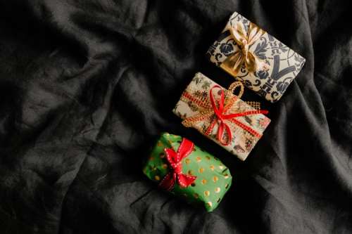 Christmas gifts on black linen bedding
