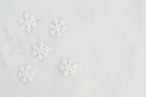 Decorative snowflakes on fresh snow
