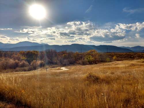 Autumn Sun over Prairie and Mountain Landscape