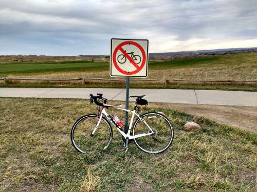 Bicycle Leaning Against No Bikes Sign