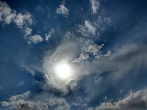 Sun Emerging from Clouds in Sky