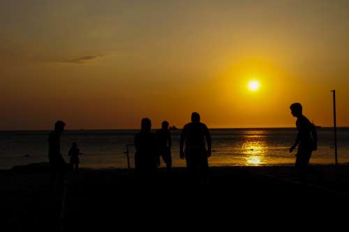 Amateurs playing football at Jumeira beach in Santa Marta, Colombia during sunset. free image