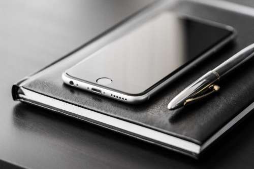 Business Gear: Smartphone, Silver Pen and Diary