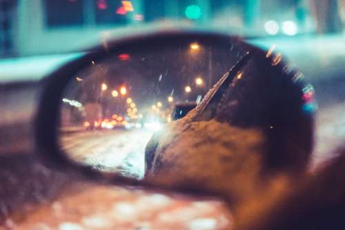 Car Side Rear-View Mirror in Snowy Night