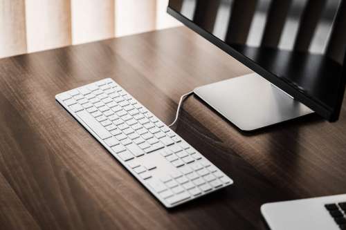Clean Setup: Keyboard and Glossy Desktop Display