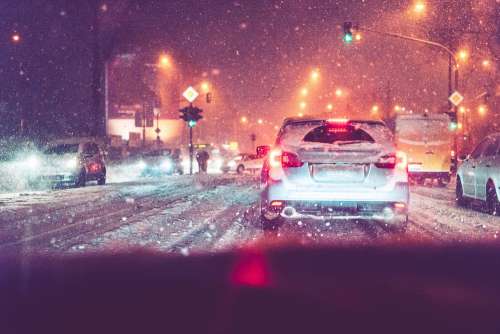 Driving in Evening Traffic Jam and Snow Calamity Weather