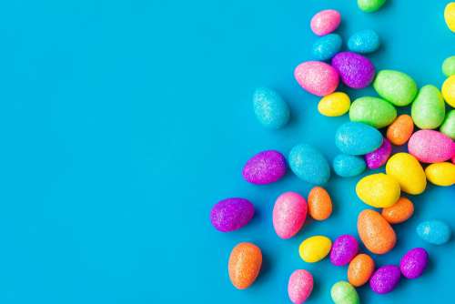 Glittering Easter Eggs on Blue Background with Space for Text