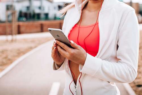 Fit Girl Listening to Music on Her iPhone