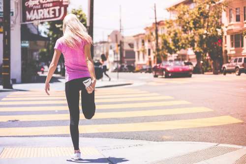 Fit Young Girl Stretching Her Legs Before Jogging Workout