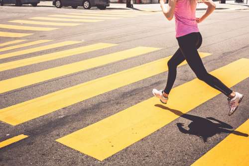Blonde Woman Running Over The Pedestrian Crossing