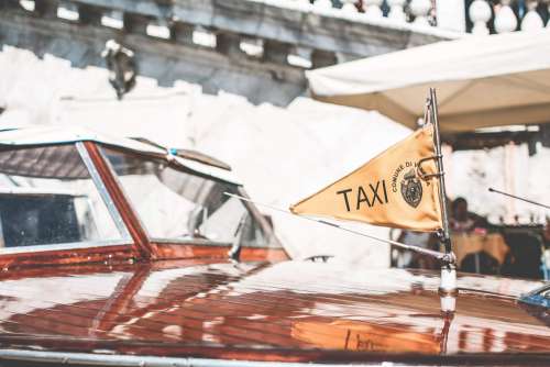 Flag on Iconic Boat Taxi in Venice, Italy