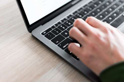 Freelance Man Typing on His Laptop Close Up