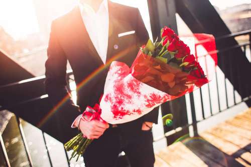 Gentleman Holding a Bouquet of Roses and Waiting for His Wife