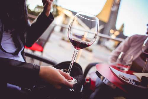 Girl Holding a Glass with Red Wine