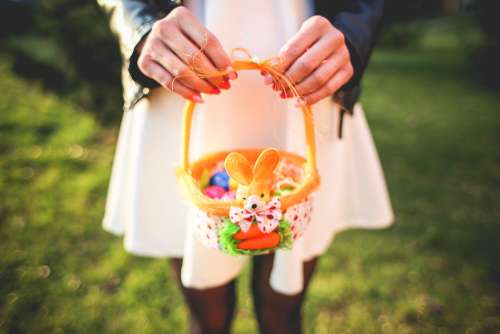 Girl Holding Basket with Colored Easter Eggs