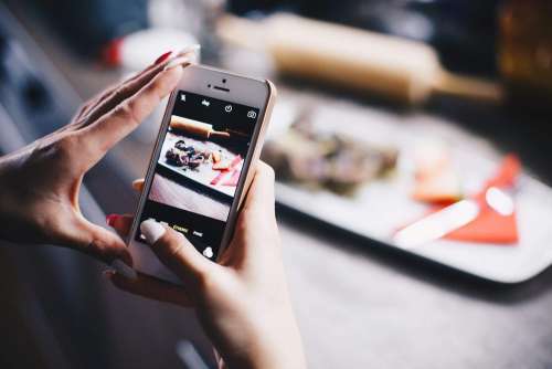 Girl Taking a Photo of Her Food with iPhone