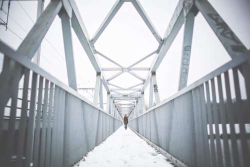 Girl Walking on Steel Bridge in Winter